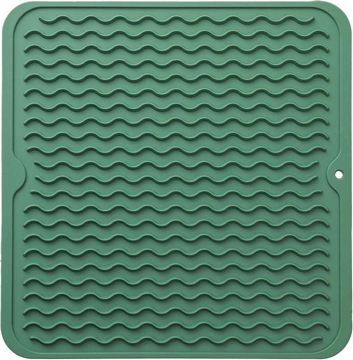 Foldable silicone kitchen mat shown partially rolled up for storage