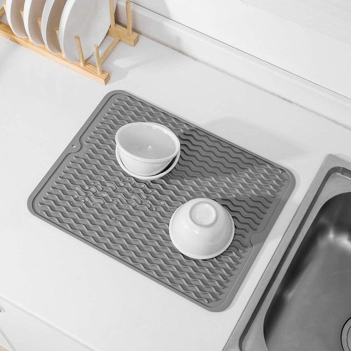 Heat-resistant counter protector mat placed under a hot baking dish