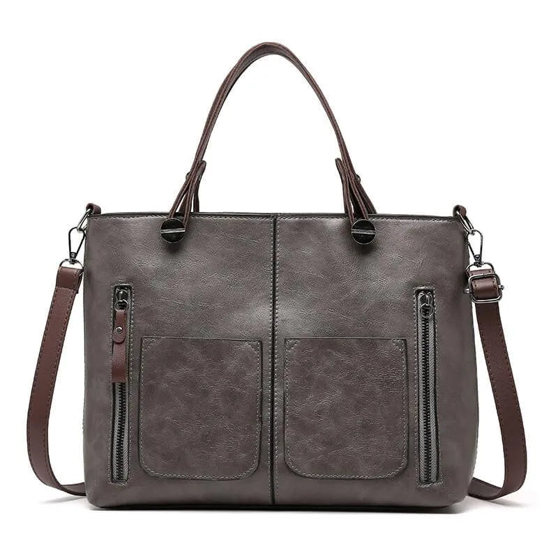 Women's grey handbag with adjustable crossbody strap and structured design