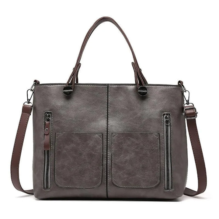 Women's grey handbag with adjustable crossbody strap and structured design