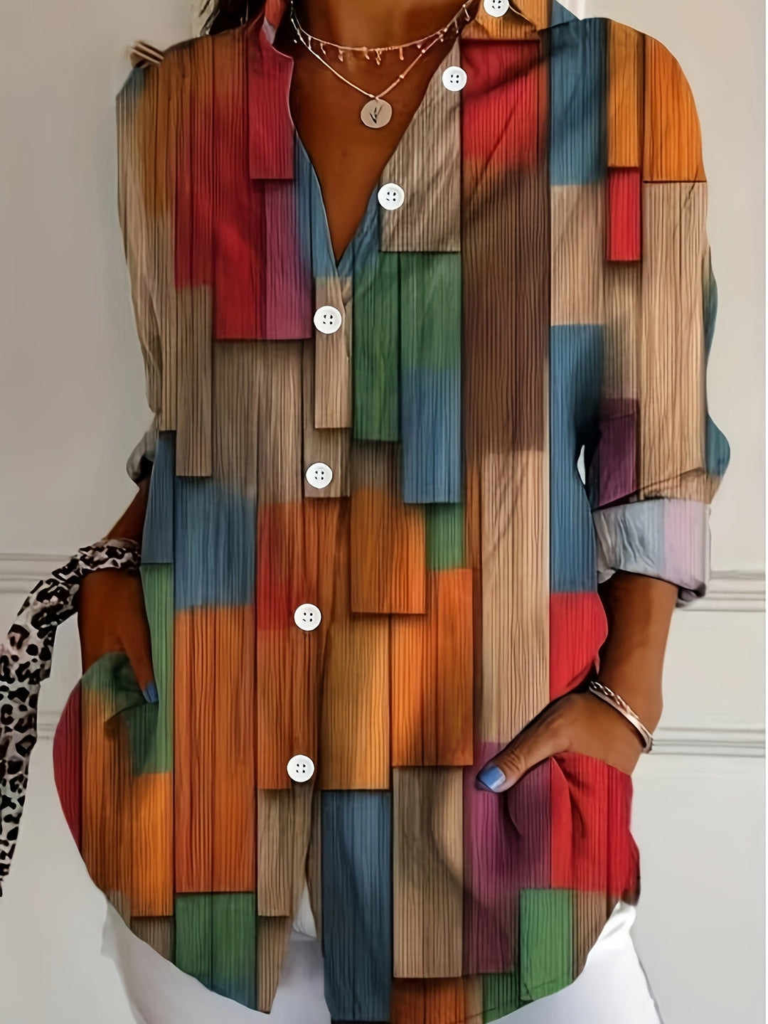 Woman wearing a colorful geometric print collared long sleeve blouse