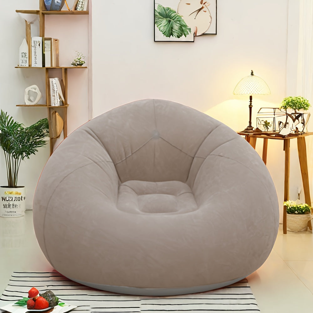 Grey inflatable lounge chair displayed in a cozy living room interior