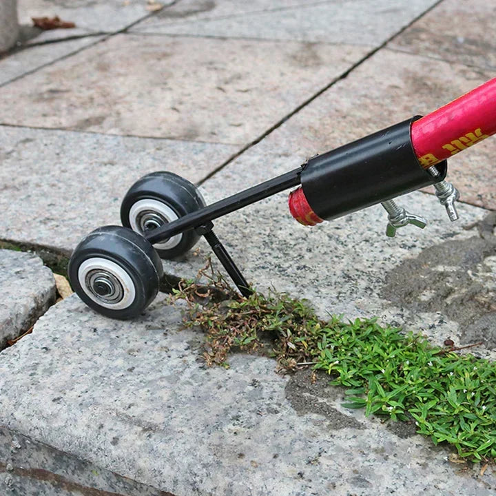 Close-up view of the weed puller tool head on stone paving