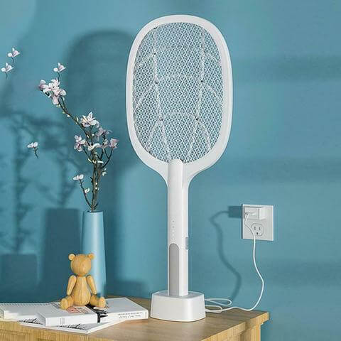 Person holding the electric bug zapper racket to demonstrate size and ease of use