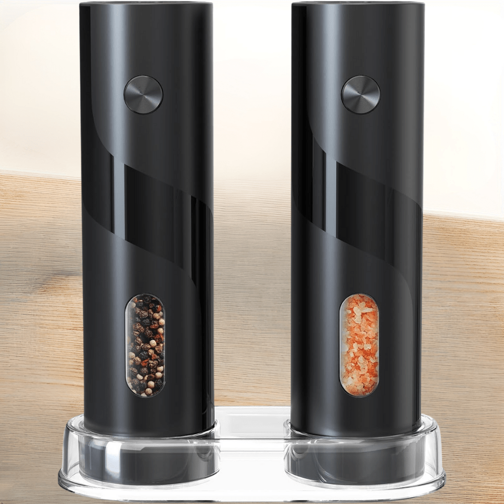Close-up view of black electric salt and pepper grinders showing transparent spice windows
