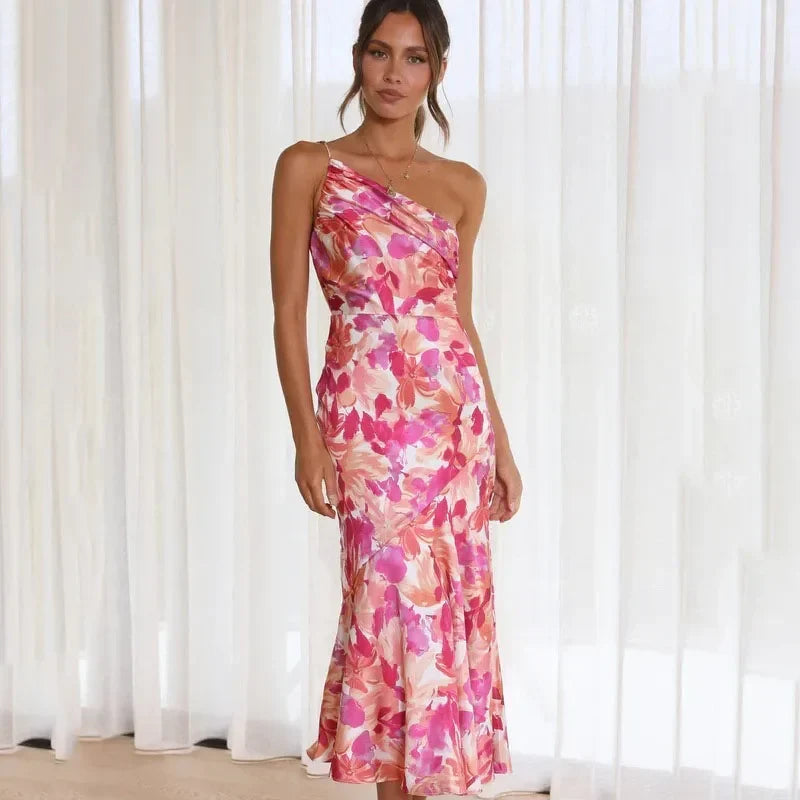 Front view of a woman wearing an elegant pink asymmetrical floral midi dress