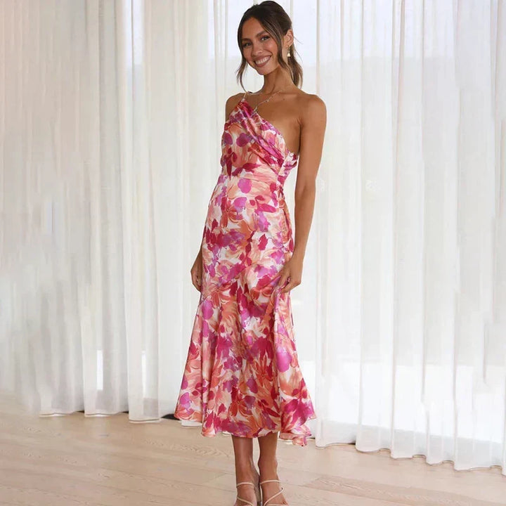 Full length front view of a model in a pink one-shoulder floral dress
