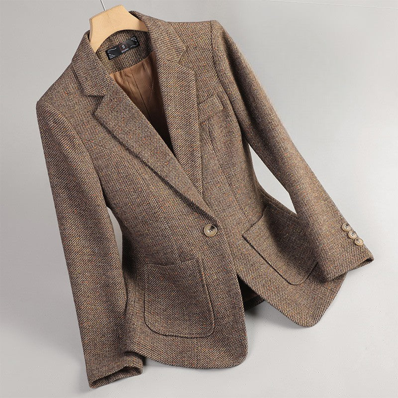 Brown tailored women's blazer jacket hanging on a wooden hanger