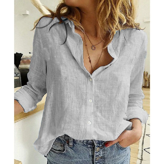 Woman wearing a light gray long sleeve button-down blouse