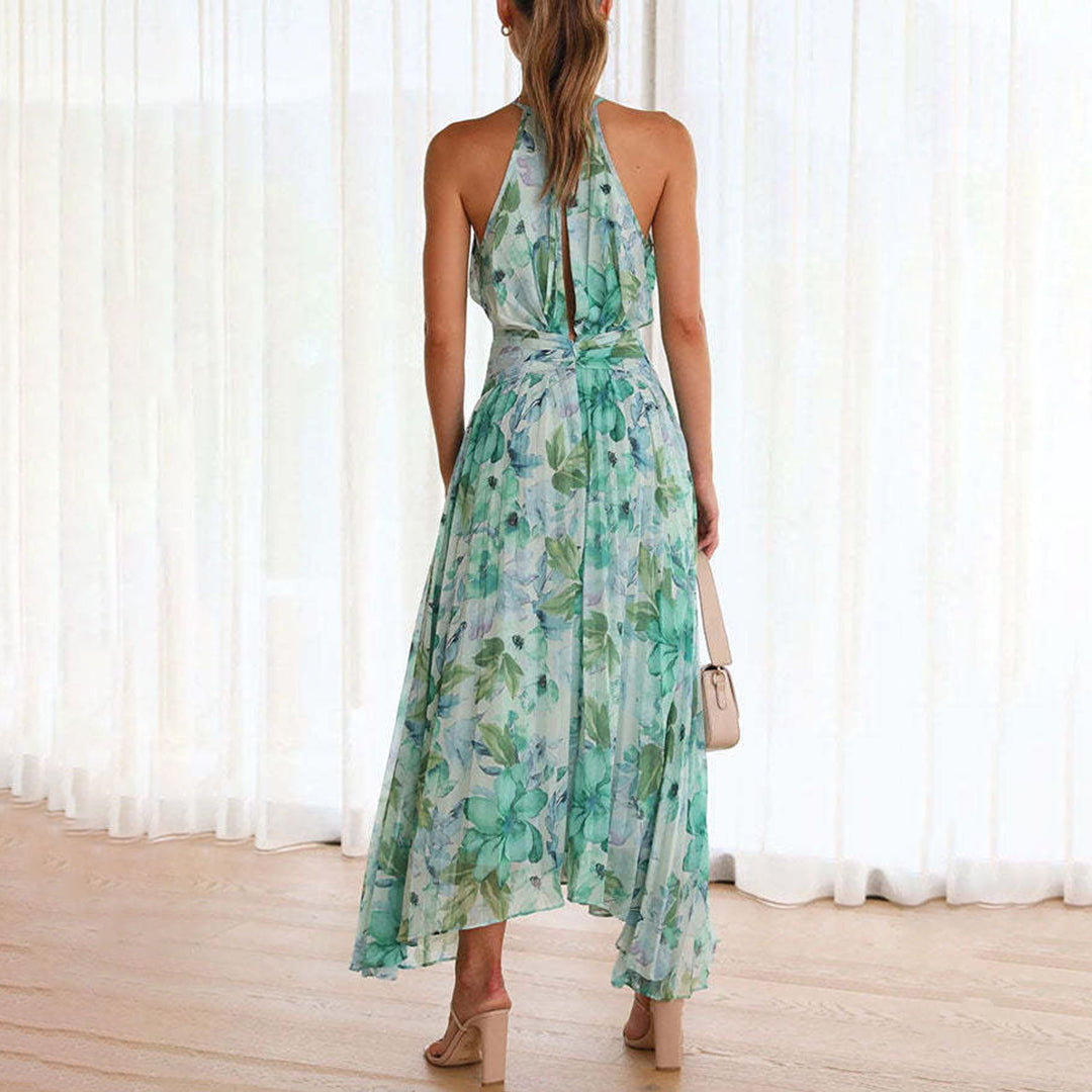 Back view of a woman modeling the flowing green floral summer maxi dress