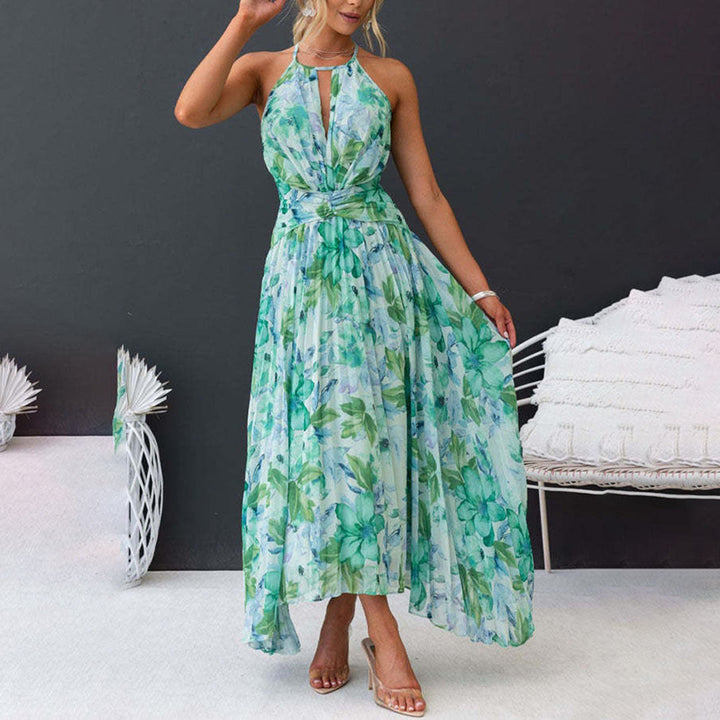 Full length view of a woman wearing a green floral halter maxi dress