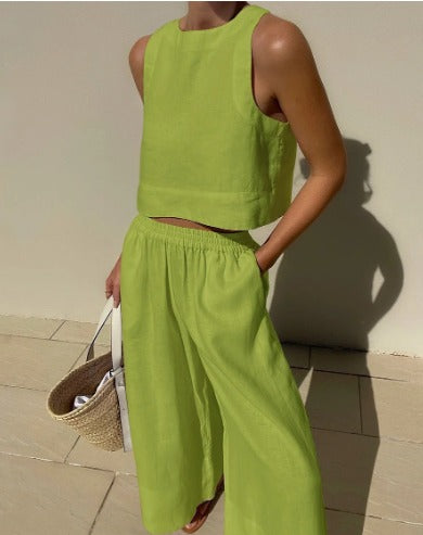 Woman wearing a green sleeveless top and matching trousers two-piece set