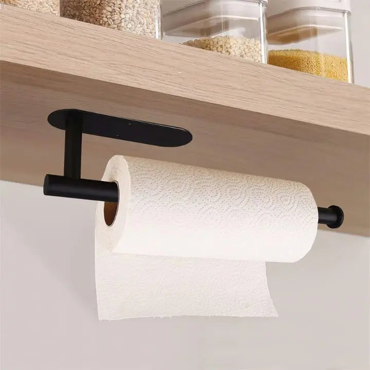 Black drill-free kitchen paper towel holder mounted under a wooden shelf
