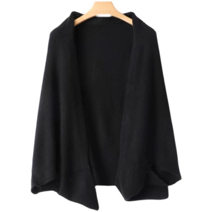 Women's elegant warm soft shawl wrap in black hanging on a wooden hanger