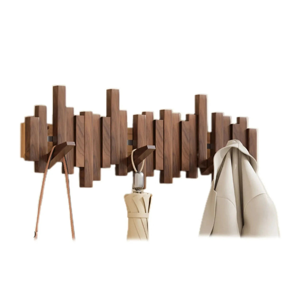 Walnut wooden piano coat rack mounted on wall with hanging coat and umbrella