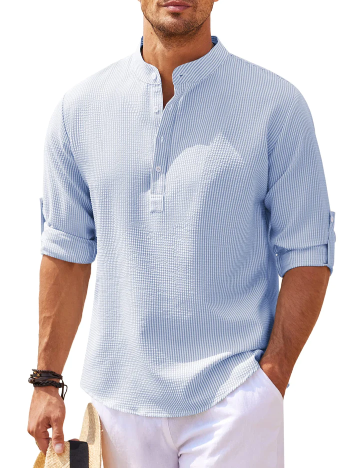 Man wearing a light blue striped long-sleeve casual shirt