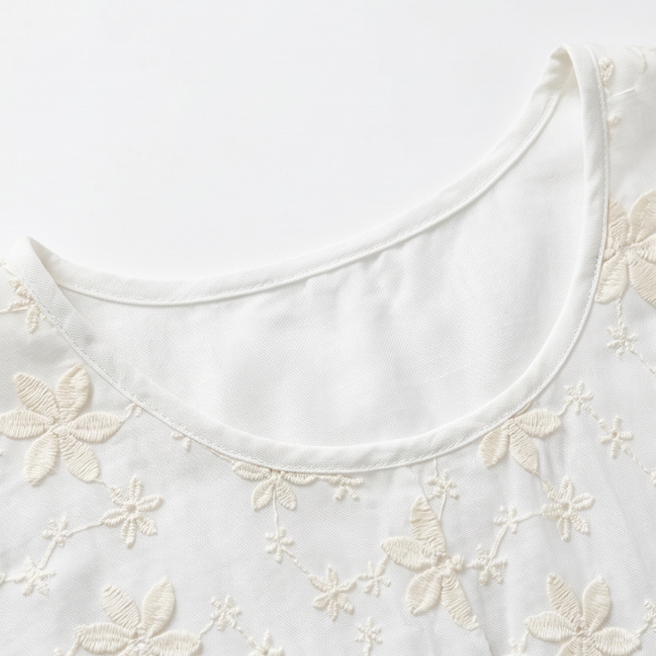 Full view of white floral embroidered peplum top styled casually