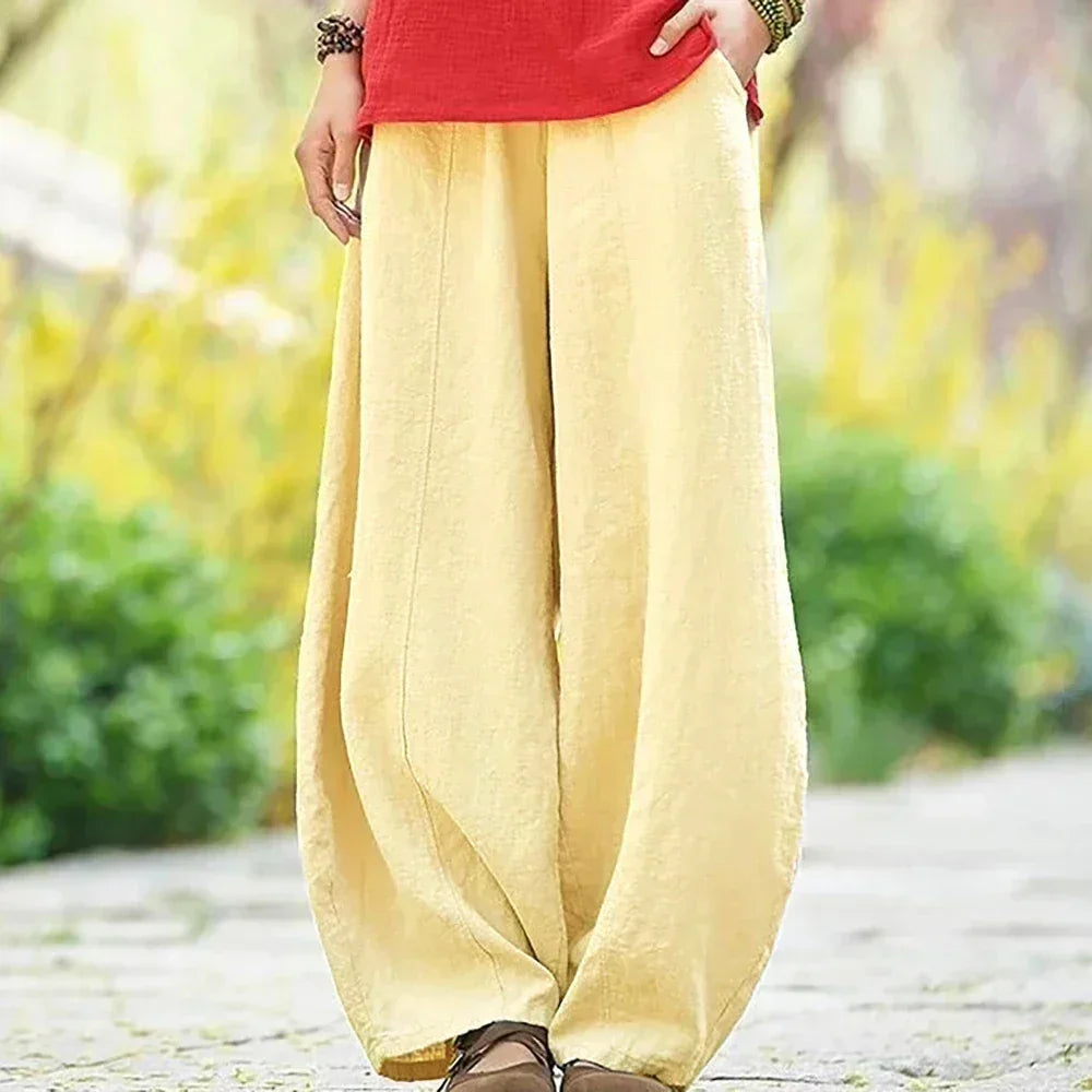 Woman wearing apricot wide leg harem pants with red top