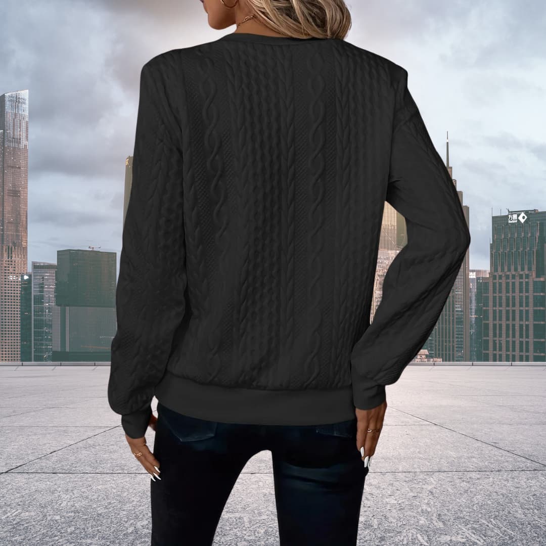 Detailed view of ribbed cuffs and hem on women's zip up sweater