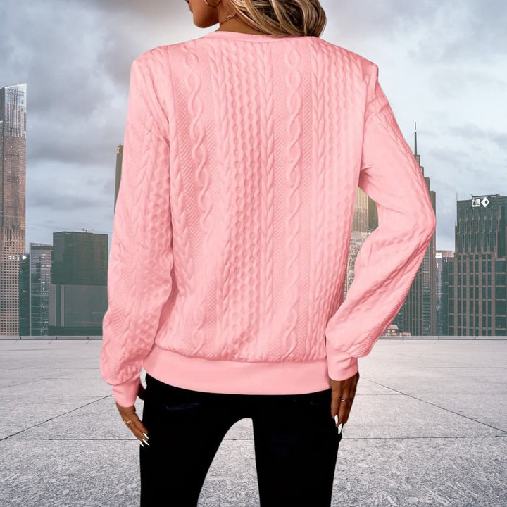 Folded stack of women's cozy knit sweaters for fall and winter wardrobe
