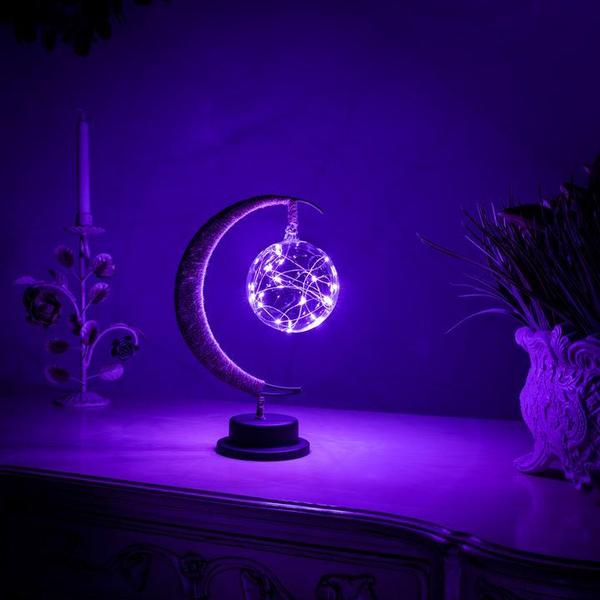 Magical purple moonlight night light glowing in a dark room