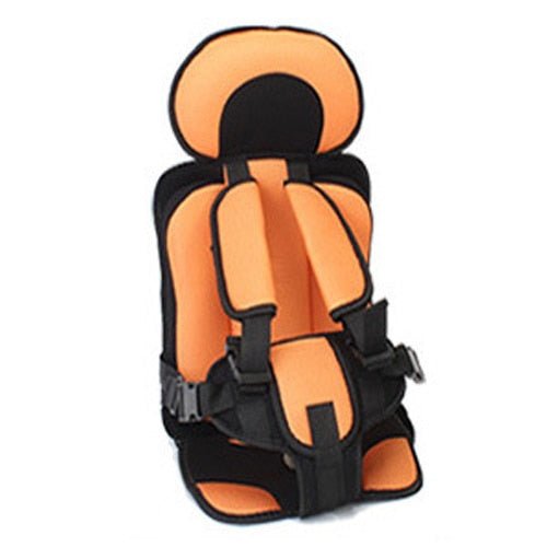 Happy toddler securely seated in the travel car seat during a road trip