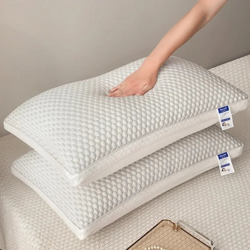 Light gray ergonomic cooling neck support pillow displayed on a bed with a hand pressing the textured surface.