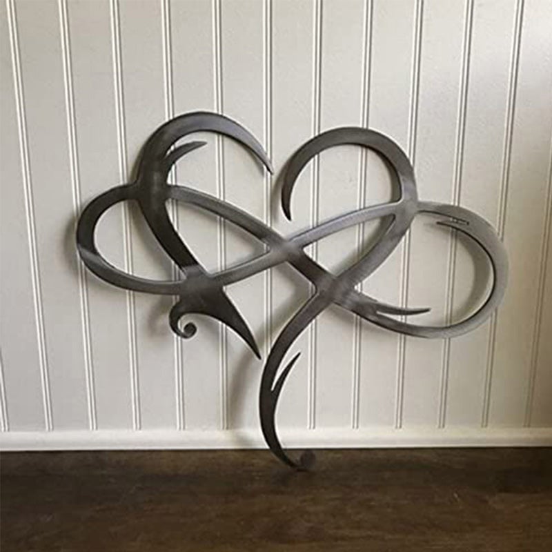 Eternal Love stainless steel wall decor in original finish mounted on white wood paneling