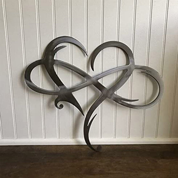 Eternal Love stainless steel wall decor in original finish mounted on white wood paneling