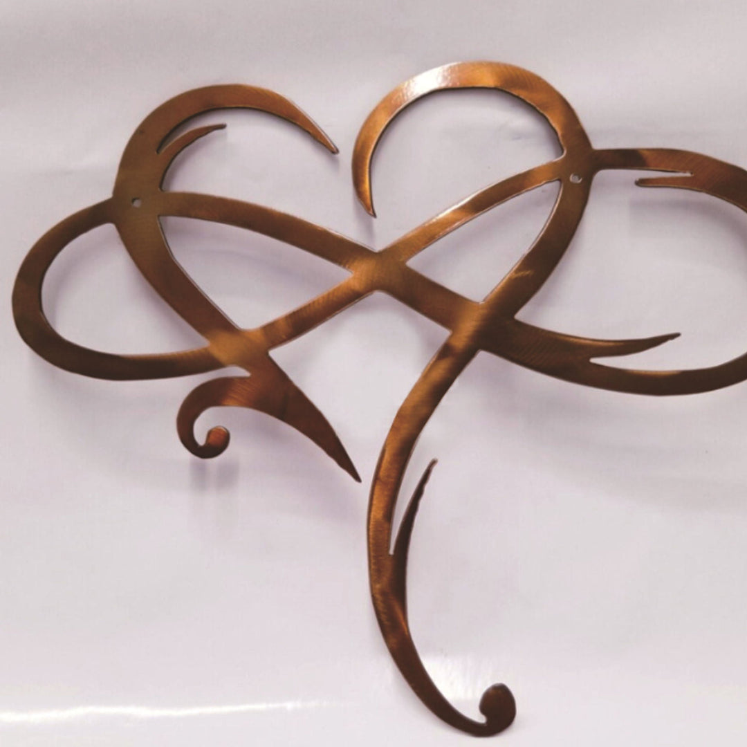 Stainless steel infinity heart wall decor closeup showing brushed metal texture