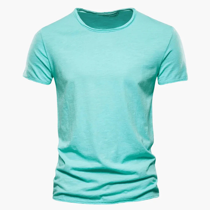 Close-up view of the raw-edge hem detail on a men's short sleeve crew neck t-shirt