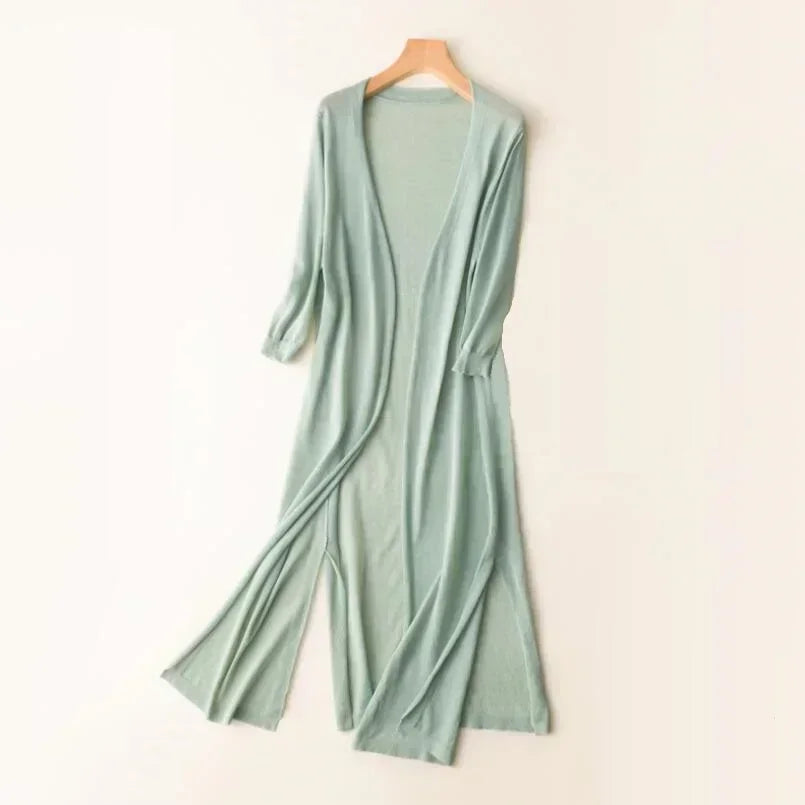 Green women's long open front cardigan displayed on a hanger