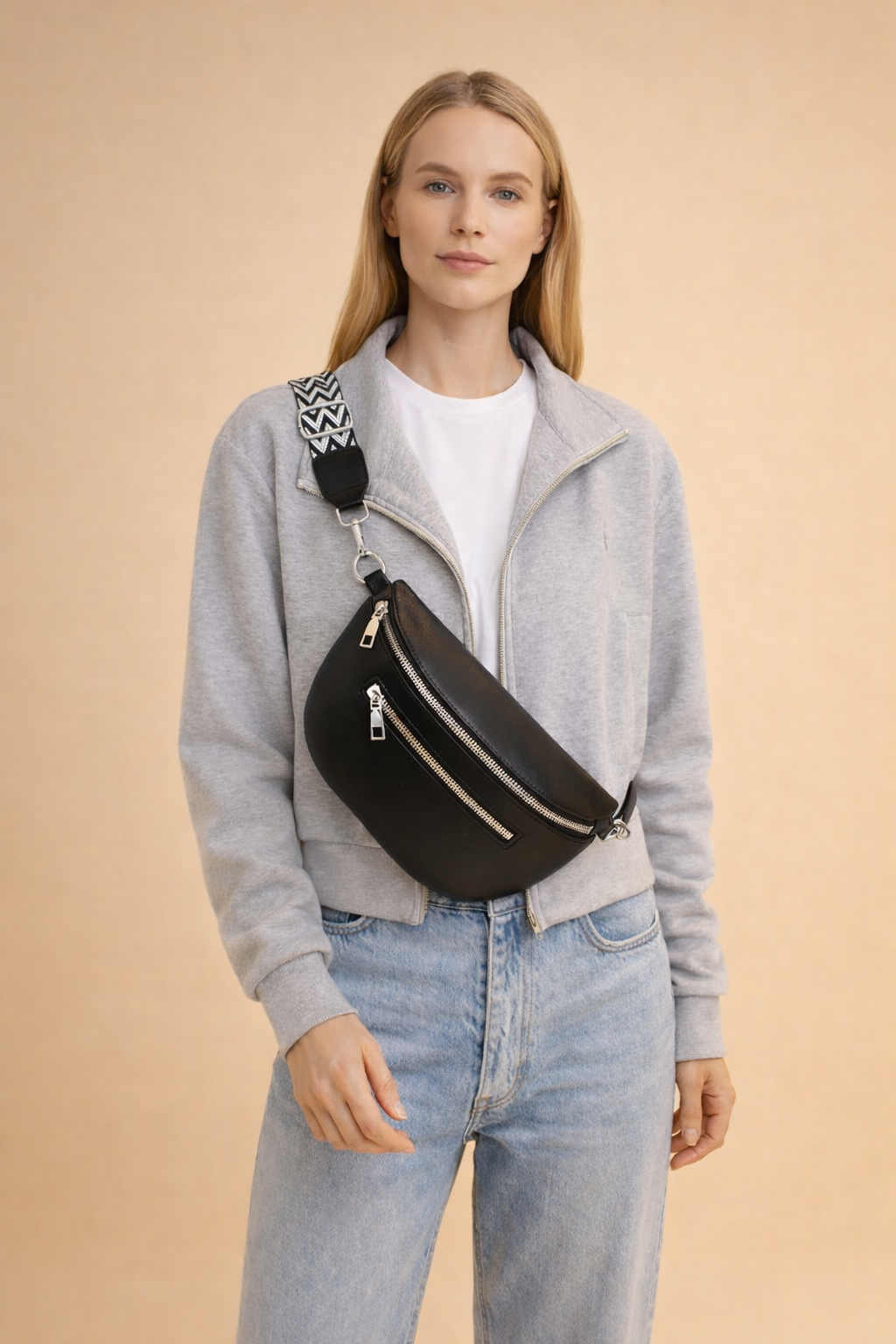 Minimalist black women's crossbody belt bag styled as a chic everyday handbag accessory