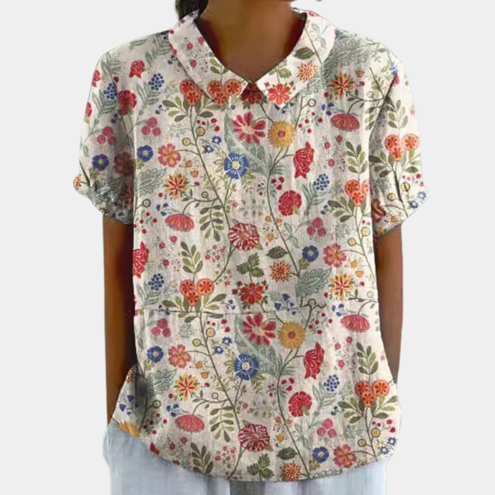 Woman wearing cream floral Peter Pan collar summer blouse