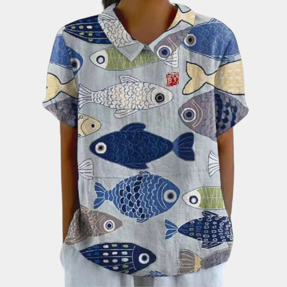 Woman wearing blue fish print short sleeve summer top