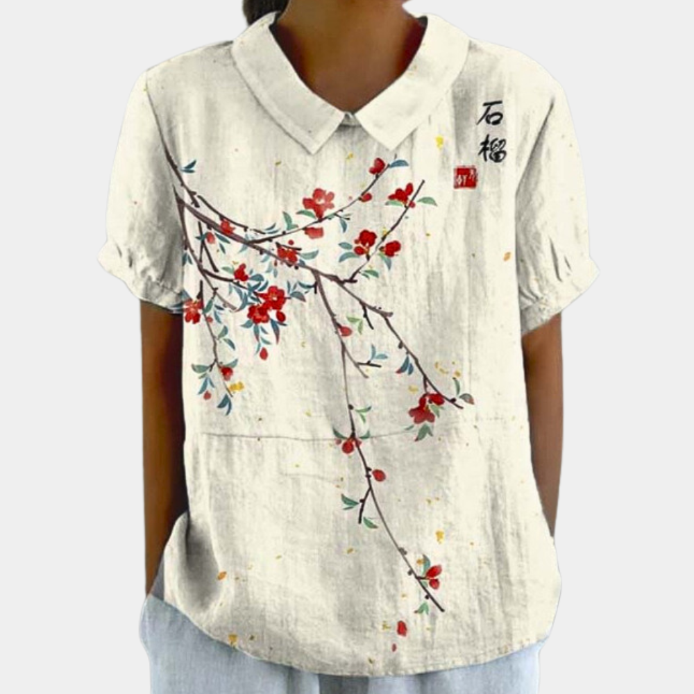 Cream floral summer blouse with blue and green botanical print and short sleeves