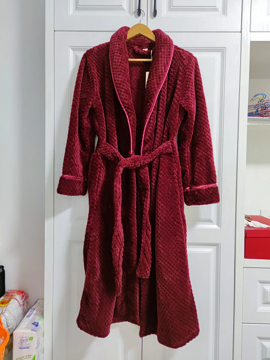 Flat lay of women's bathrobe showing luxurious texture and generous length