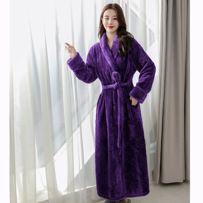 Woman wearing purple plush long bathrobe by window
