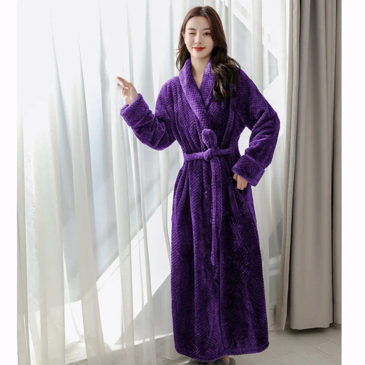 Woman wearing purple plush long bathrobe by window