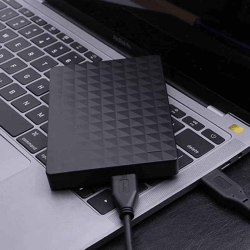 8TB portable external hard drive connected to a laptop on a desk