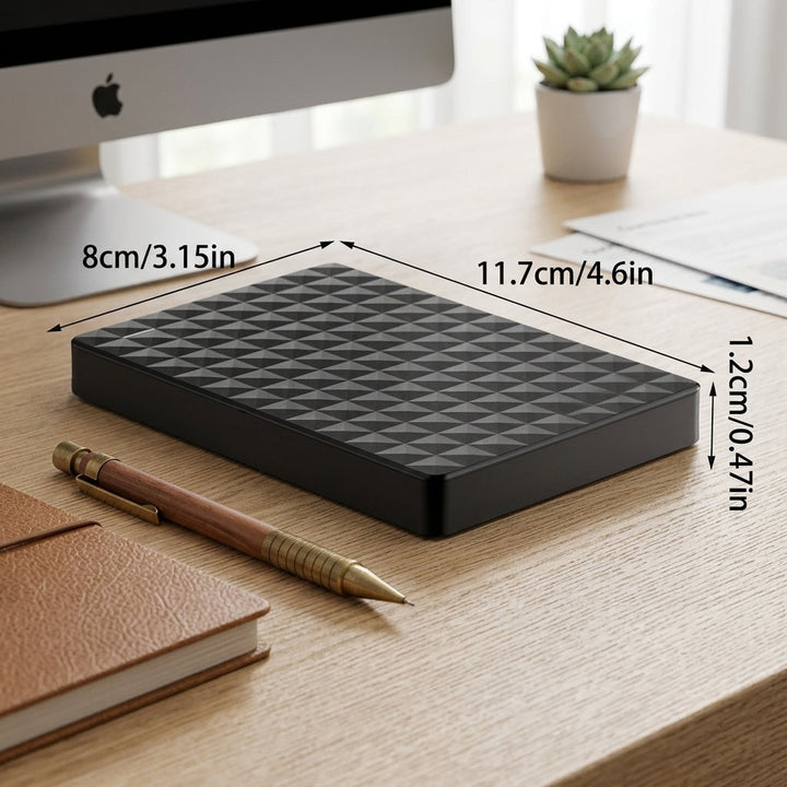 Hand holding lightweight external hard drive for travel convenience