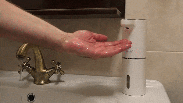 Modern kitchen gadget automatic soap dispenser placed near sink faucet