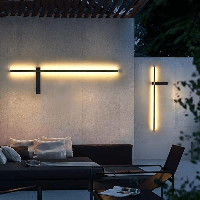 Modern outdoor LED wall lamp mounted on a patio wall emitting warm light