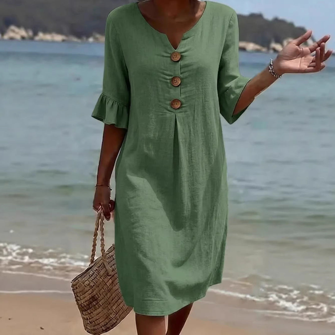 Summer beach dress featuring short flutter sleeves and V-neckline