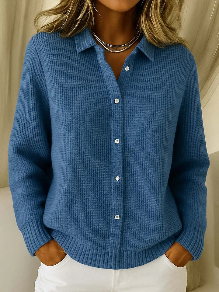 Woman wearing a blue knit button-up cardigan with long sleeves