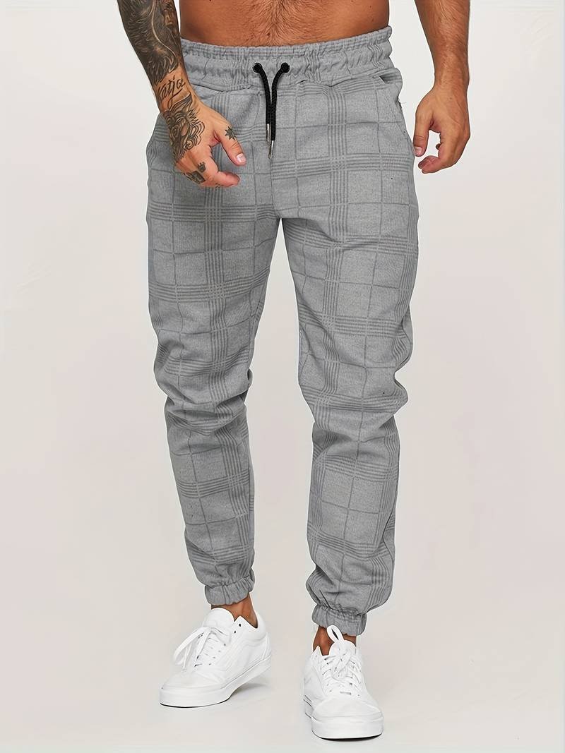 Man wearing gray modern checked jogger pants with white sneakers