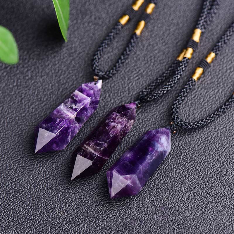 Multiple amethyst crystal point pendants displayed together