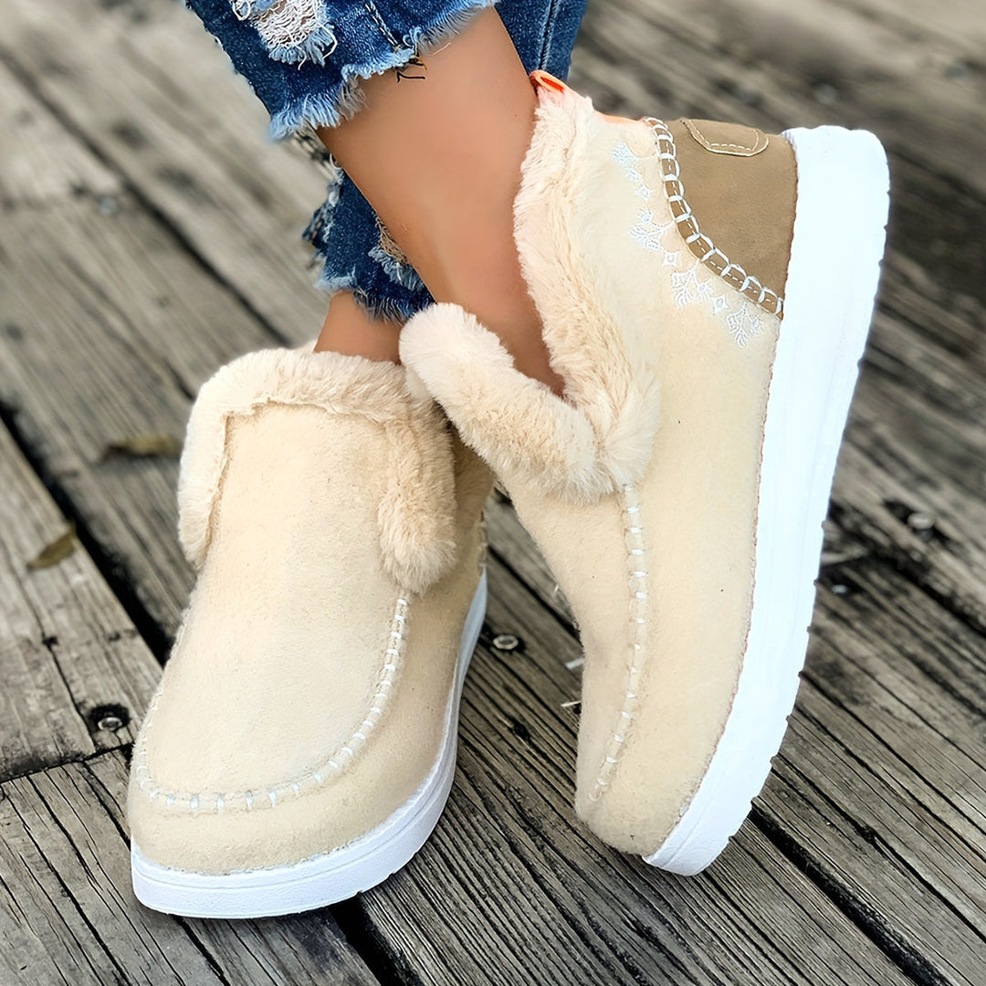 Pair of stylish women's winter slippers with soft plush and secure grip
