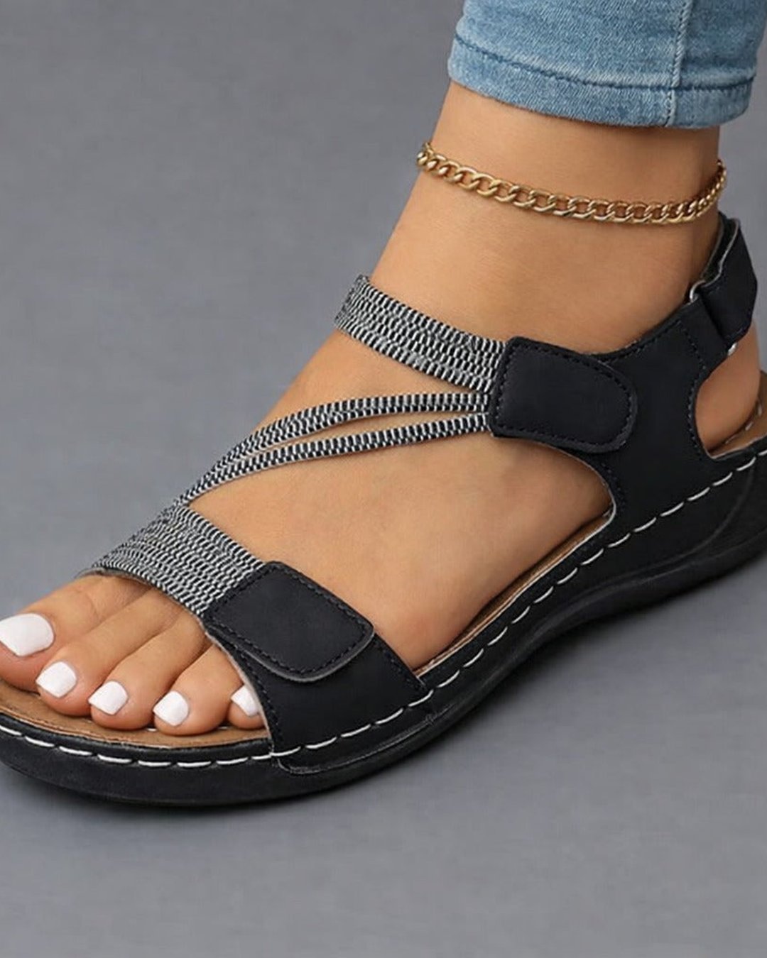 Top-down view of womens summer footwear featuring cushioned footbed and dual straps.