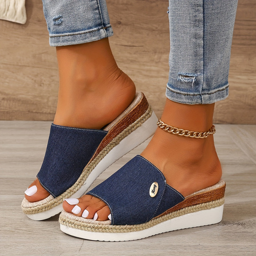 Royal blue height-increasing wedge slide sandal styled with denim